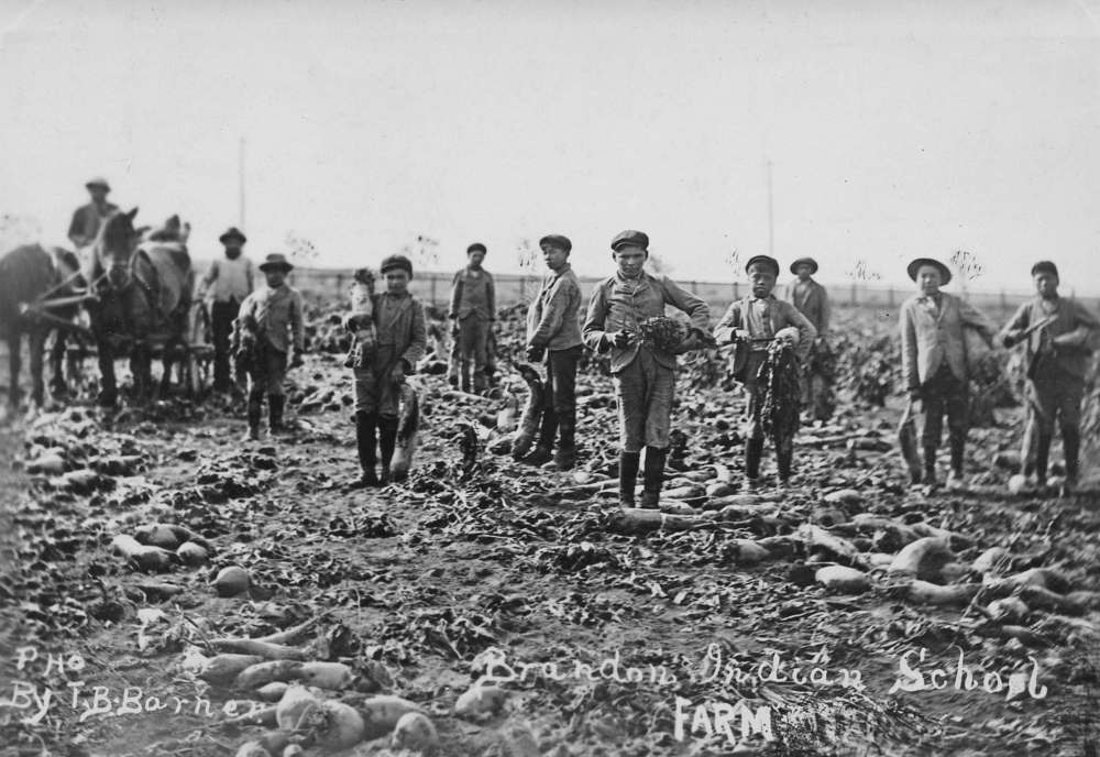 Students at the Brandon Residential School work on the school’s farm in this photo taken sometime betwen 1913 and 1915. (SJ McKee Archives, Brandon University)