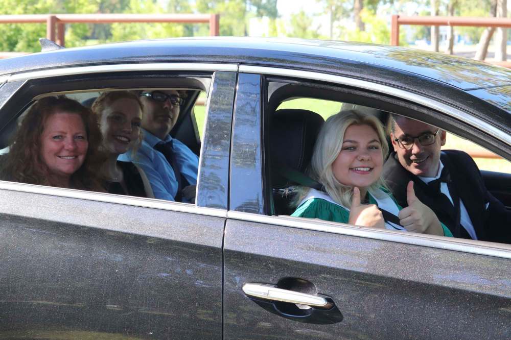 Mackenzie Bell gives a double thumbs-up as she and her family wait in line during Monday’s École secondaire Neelin High School graduation ceremony, which took place on the Keystone Centre grounds in accordance with the province’s latest health restrictions. After she received her diploma, Bell told the Sun she is going to attend the Massachusetts College of Pharmacy and Health Sciences in Boston to study medicine. (Kyle Darbyson/The Brandon Sun)