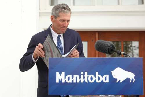 Premier Brian Pallister stands at the podium after announcing on Tuesday that he'll be stepping down. (Tim Smith/The Brandon Sun)