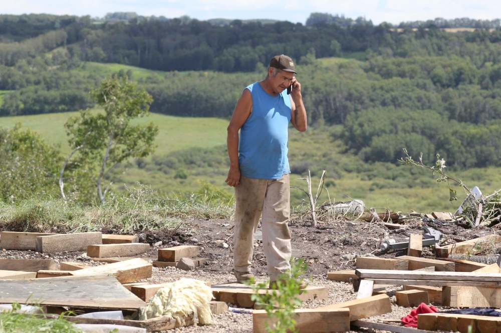 Eva Wasney / The Brandon Sun
Sidney Longclaws walks through the debris of a Waywayseecappo First Nation home that was destroyed during Monday's tornado-producing storm.