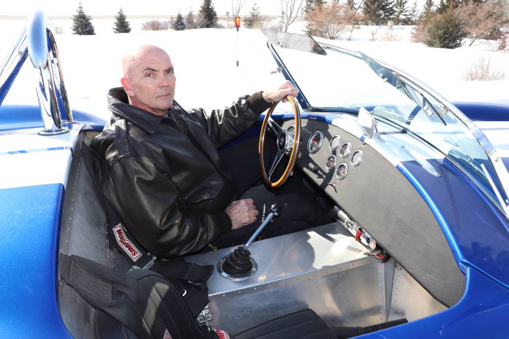 Kyle Darbyson/The Brandon Sun
LEFT: Chester gets behind the wheel of his replica Shelby Cobra on Thursday morning in the RM of Cornwallis just outside of Brandon. After working for the Canadian Pacific Railway for almost four decades, Chester told the Sun that he is enjoying his retirement, especially with car projects like this to keep him company. RIGHT: Chester showcases the back end of his replica Shelby Cobra on Thursday morning near Grand Valley Road. Chester told the Sun that MarVal Autobody out of Killarney is responsible for the classic blue-and-white paint job.