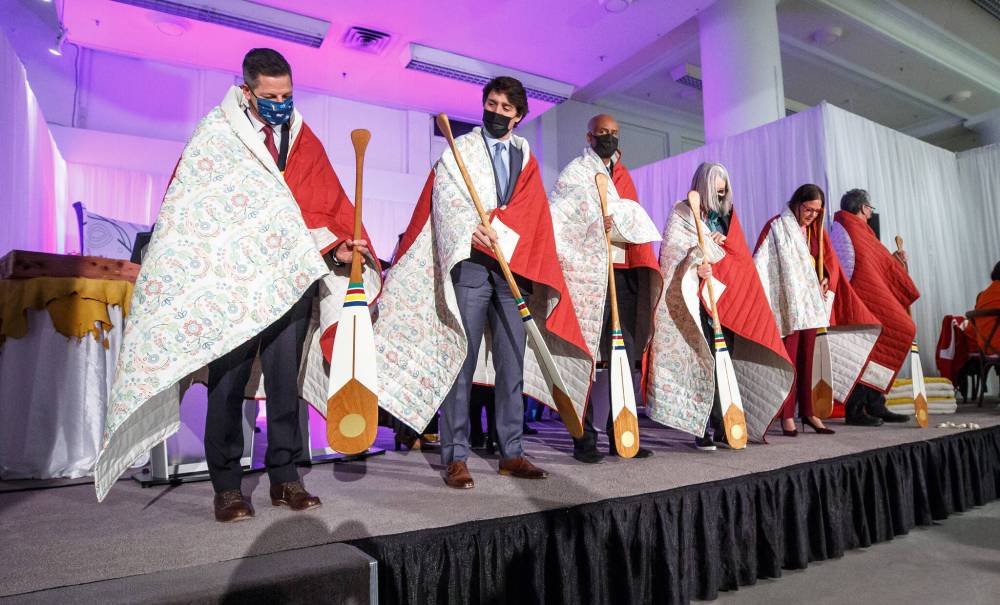 Winnipeg Free Press
Winnipeg Mayor Brian Bowman (from left), Prime Minister Trudeau, federal Housing Minister Ahmed Hussen, federal Indigenous Services Minister Patty Hajdu, Manitoba Premier Heather Stefanson, and federal Northern Affairs Minister Dan Vandal receive commissioned blankets from the Southern Chiefs Organization and paddles from the Hudson’s Bay Company at Friday’s ceremony to mark the launch of the redevelopment of the building.