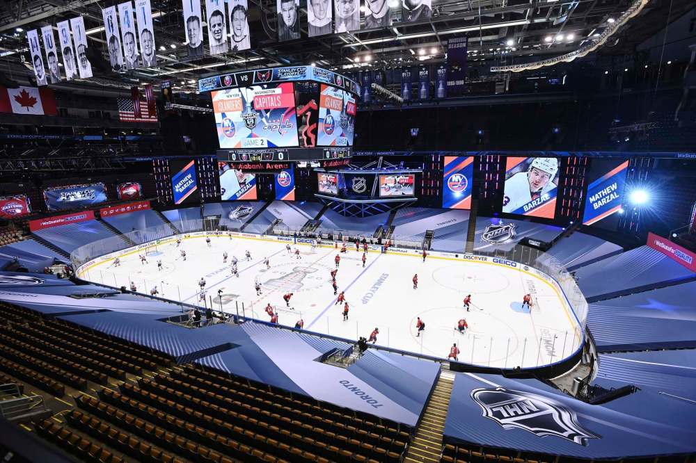 New York Islanders and Washington Capitals players warm up prior to NHL Eastern Conference Stanley Cup playoff hockey action in Toronto on Aug. 14. (The Canadian Press)