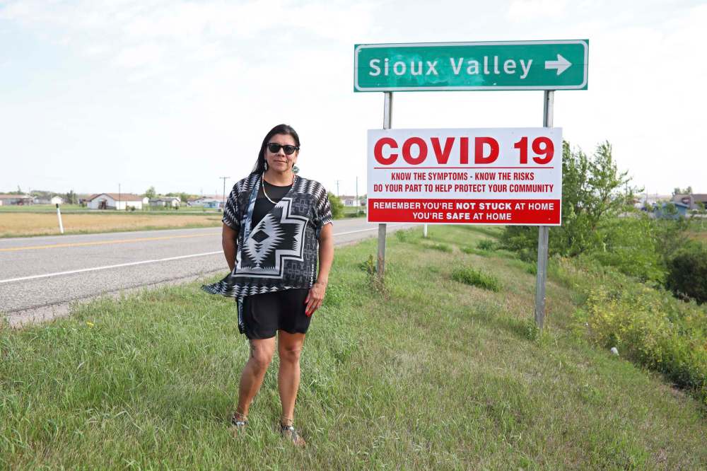 Sioux Valley Dakota Nation Chief Jennifer Bone stands in front of one of the community’s COVID-19 awareness signs along the Eva McKay Memorial Highway. (Tim Smith/The Brandon Sun)