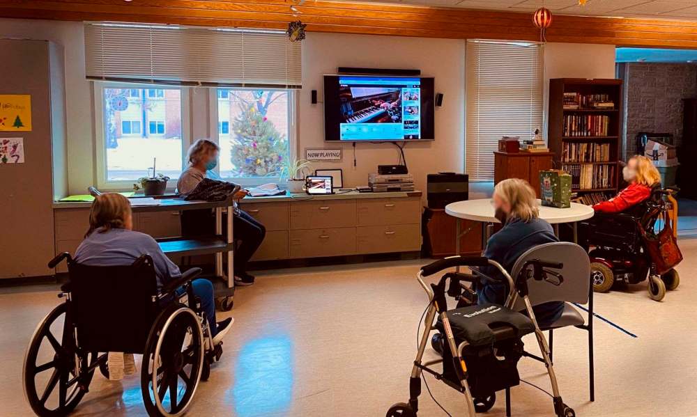 Residents at Luther Home in Winnipeg enjoy a physically-distanced viewing of a piano recital themed Home for the Holidays to complement their Ukrainian Christmas festivities, at test run of Sharing is Caring, thanks to piano teacher Corey Francis and his students Jan. 7. (Submitted)