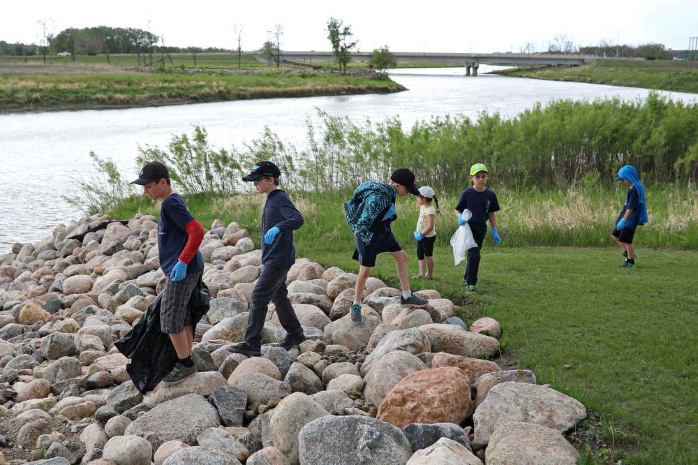 LEFT: Members of the Navy League Cadet Corps Stan Hawitt #4 help pick up garbage during the annual Spring Cleanup and BBQ at the Riverbank Discovery Centre in 2018. (File) RIGHT: Navy league member Niko Borkent, 10, is seen in his uniform. (Submitted)