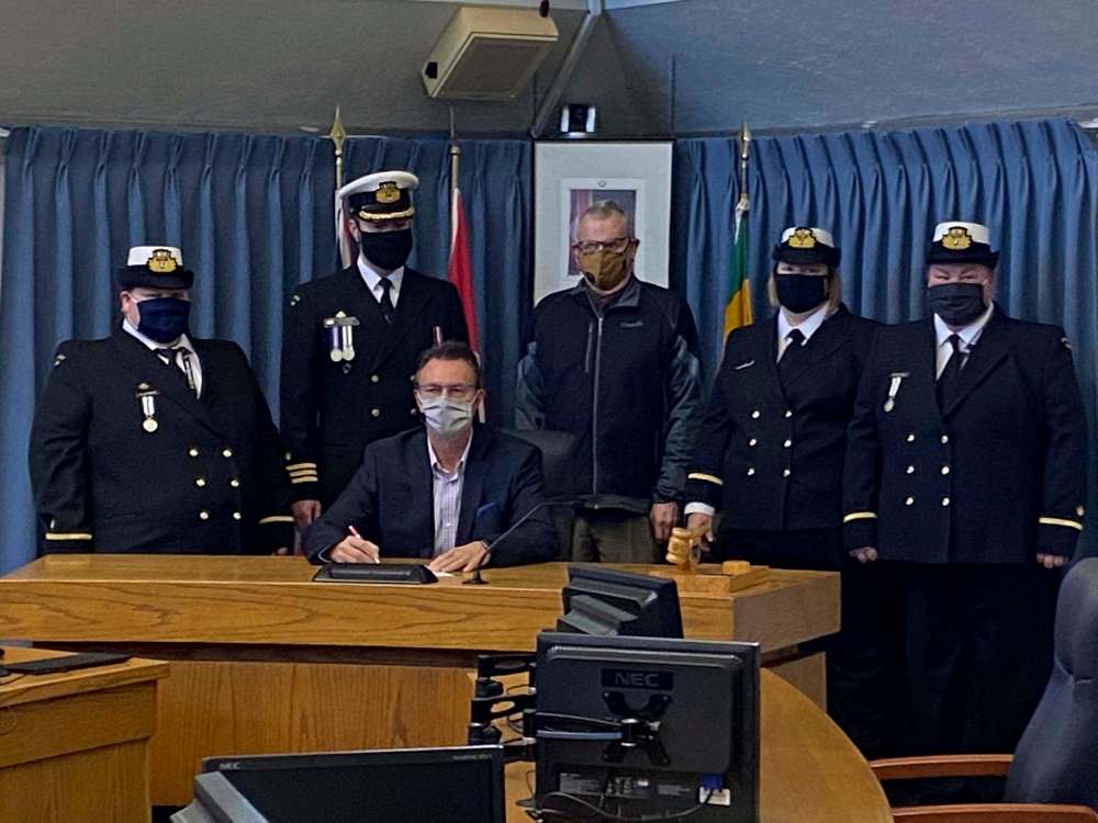 Mayor Rick Chrest, sitting, signs a proclamation for the 125th anniversary of the navy league in Canada late last year. Also pictured is, from left, is acting sub-Lt. Amanda Slashinsky, Cdr. Clayton Kozak, acting sub-Lieut. Charlene Fontaine and acting sub-Lieut. Melissa Slashinsky. (Submitted)
