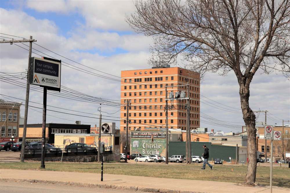 A pedestrian walks by an open section of downtown Brandon on Tuesday afternoon. The 6,500-square-metre site was originally designated to house a downtown campus for Brandon University. However, BU officials announced on Monday the project has been shelved due to the lack of a private-sector lead to develop the site. (Kyle Darbyson/The Brandon Sun)