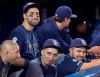 FILE - In this Sept. 28, 2019, file photo, Tampa Bay Rays' Kevin Kiermaier, top left, relaxes in the dugout with teammates in the fourth inning of a baseball game against the Toronto Blue Jays in Toronto. Major League Baseball’s average salary as opening day approached remained virtually flat at around $4.4 million for the fifth straight season, according to a study of contracts by The Associated Press. (Fred Thornhill/The Canadian Press via AP, File)
