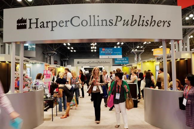 FILE - This May 28, 2015 file photo shows attendees at the HarperCollins Publishers booth during BookExpo America in New York. Publishing's annual national convention, BookExpo, has been postponed until July. Organizers cited concerns about the coronavirus in rescheduling the gathering, originally scheduled to take place in late May at the Jacob Javits Convention Center in Manhattan. (AP Photo/Mark Lennihan, File)