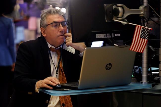 Trader John Bishop works on the floor of the New York Stock Exchange, Monday, Feb. 24, 2020.Markets are down across Europe and Asia, while futures for U.S. benchmarks have also dropped sharply. (AP Photo/Richard Drew)