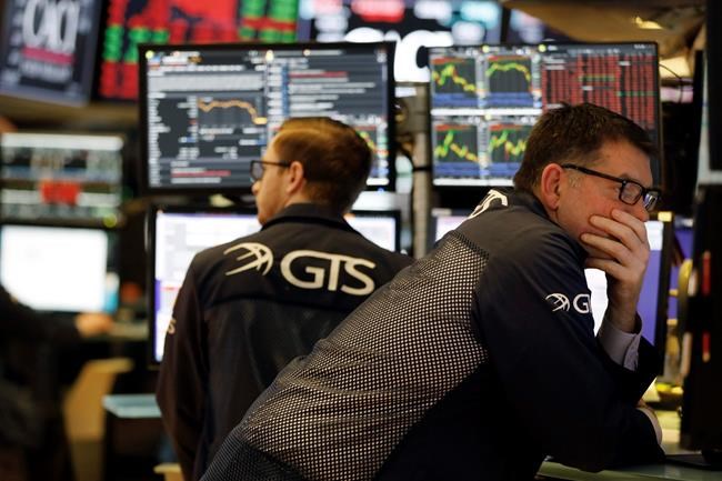 Specialist David Haubner, right, works on the floor of the New York Stock Exchange, Wednesday, March 11, 2020. Stocks are closing sharply lower on Wall Street, erasing more than 1,400 points from the Dow industrials, as investors wait for a more aggressive response from the U.S. government to economic fallout from the coronavirus. (AP Photo/Richard Drew)