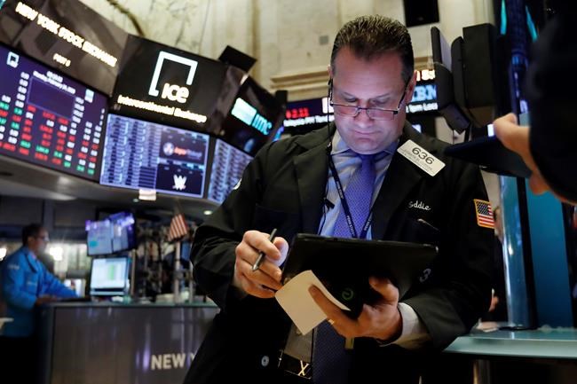 Trader Edward Curran works on the floor of the New York Stock Exchange, Monday, Feb. 24, 2020. Stocks are opening sharply lower on Wall Street, pushing the Dow Jones Industrial Average down more than 700 points, as virus cases spread beyond China, threatening to disrupt the global economy. (AP Photo/Richard Drew)