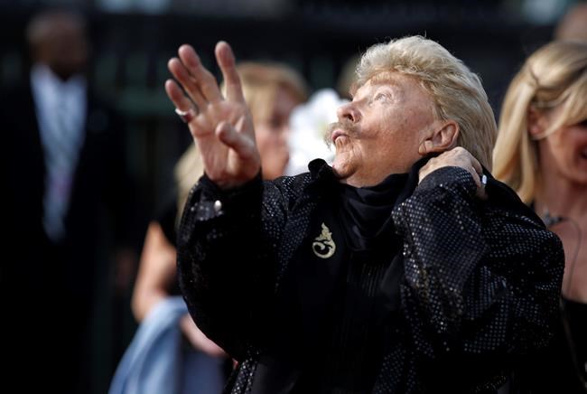 FILE - In this Friday, Jan. 14, 2011, file photo, Rip Taylor arrives at the 16th Annual Critics' Choice Movie Awards in Los Angeles. Taylor, the mustached comedian with a fondness for confetti-throwing who became a television game show mainstay in the 1970s, died Sunday, Oct. 6, 2019. He was 84. (AP Photo/Matt Sayles, File)