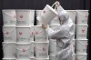 A worker in protective gear stacks plastic buckets containing medical waste from coronavirus patients at a medical center in Daegu, South Korea, Monday, Feb. 24, 2020. South Korea reported another large jump in new virus cases Monday a day after the the president called for