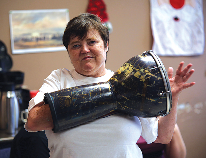 Terry Campbell poses for the camera as she plays a drum beat. (Michael Lee/The Brandon Sun)