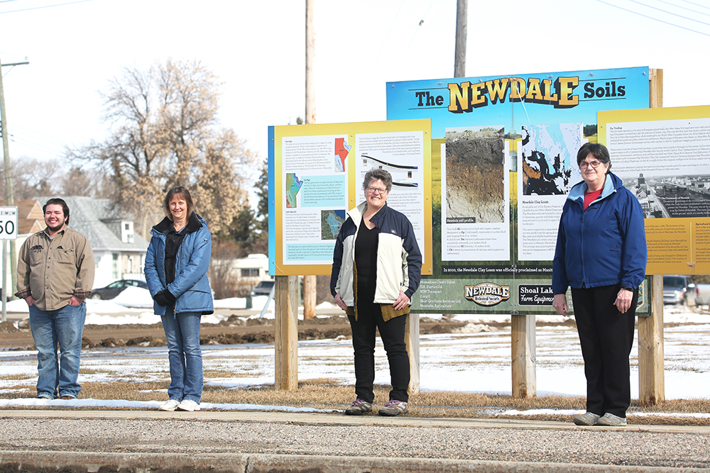 Members of the Newdale Historical Society – including Chase Wasicuna, Cindy Dalke, Helen Caird and Pat Baker – pose for a group photo in front of the community's local history display on April 7. The society is currently putting together a new book that chronicles the last 20 years of Newdale's history. The one society member who is missing from this photo is treasurer Tara Pedersen. (Kyle Darbyson/The Brandon Sun)