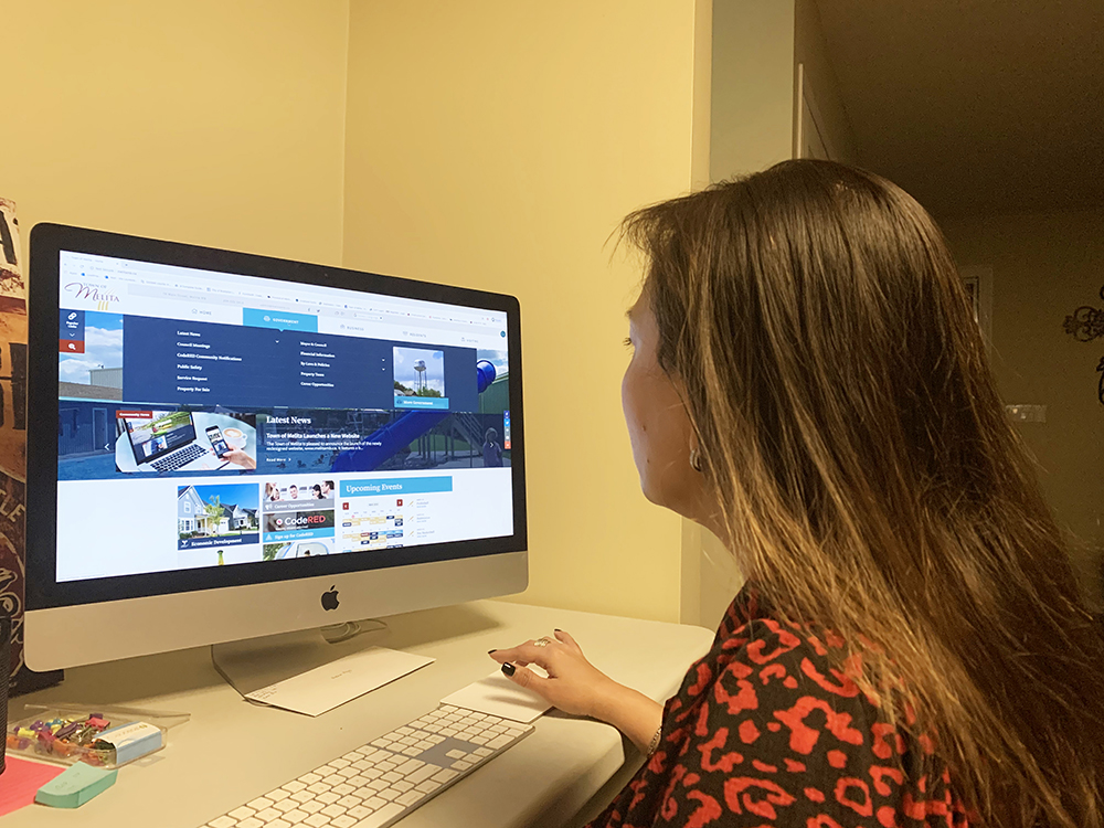 Former Town of Melita economic development officer Iris Vercaigne checks out the municipal government's new official website on March 2. Vercaigne played a pivotal role in  redesigning the town website, which officially launched on Feb. 28. (Submitted)