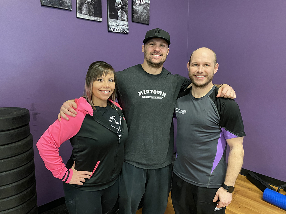 Midtown Barbell owner Dave Beakley, middle, poses for a photo with a pair of Brandon power lifters during a workshop at Anytime Fitness on March 15. (Submitted)