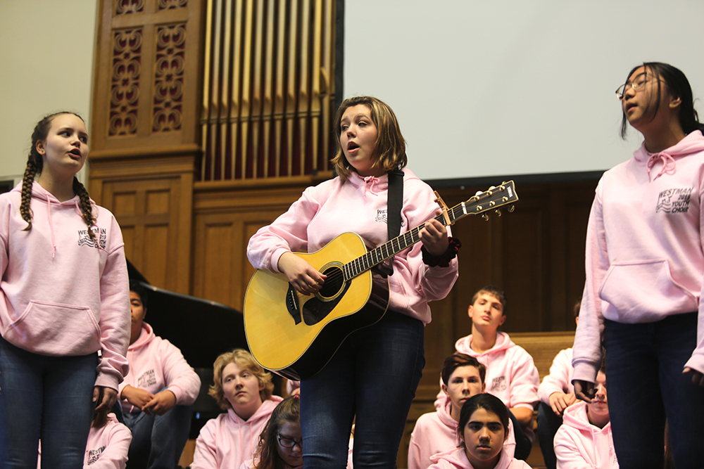 Brandon student Emily Dejarlais busts out a guitar to add some accoustic vibes to the Westman Youth Choir's Oct. 22 performance in Brandon. (Kyle Darbyson/The Brandon Sun)
