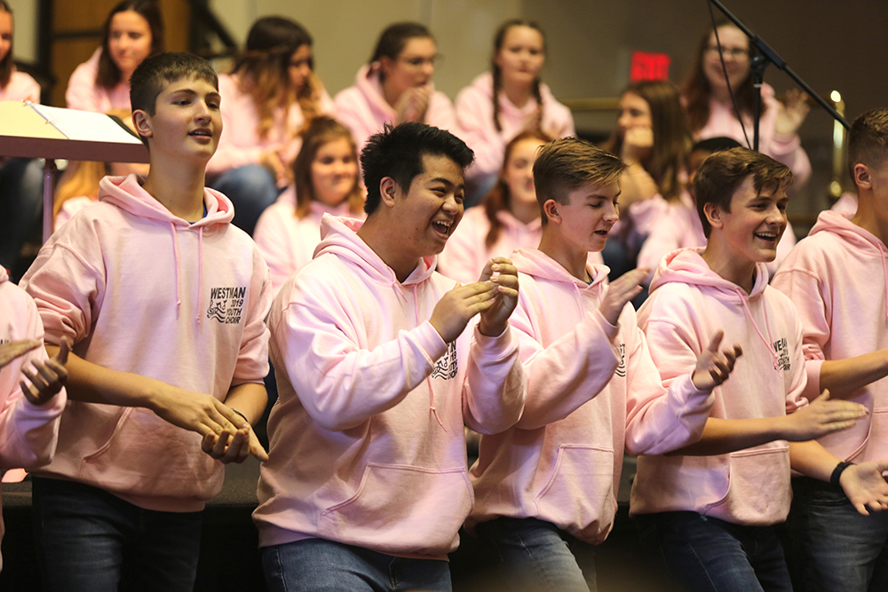 Members of the Westman Youth Choir try to pump up the crowd by stomping and clapping during their performance of a traditional Georgian song called 