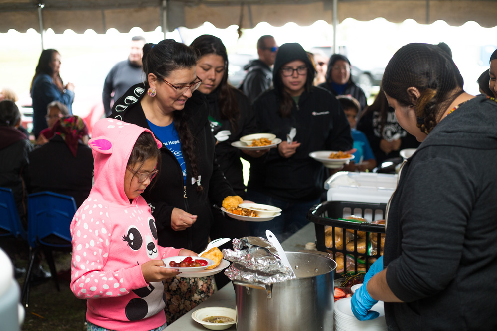 Crocus Big Eagle, 8, and Juanita McArthur Big Eagle from Pheasant Rump Nakota Nation, Sask. are fed lunch by Breanne Taylor at the Dakota Tiwahe Services and Jordan's Principal hosted Sioux Valley Dakota Nation Culture Camp on Aug. 27.  (Chelsea Kemp/The Brandon Sun)