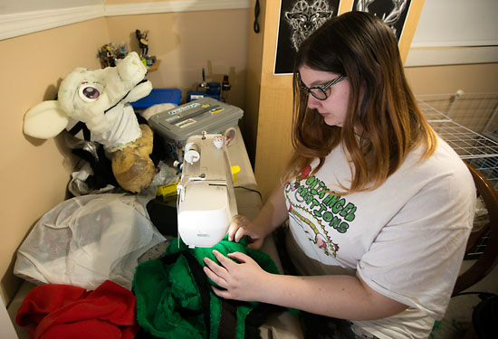 Onix Collette, local fur suit designer, adds some final touches to a custom fur suit on Nov. 14.