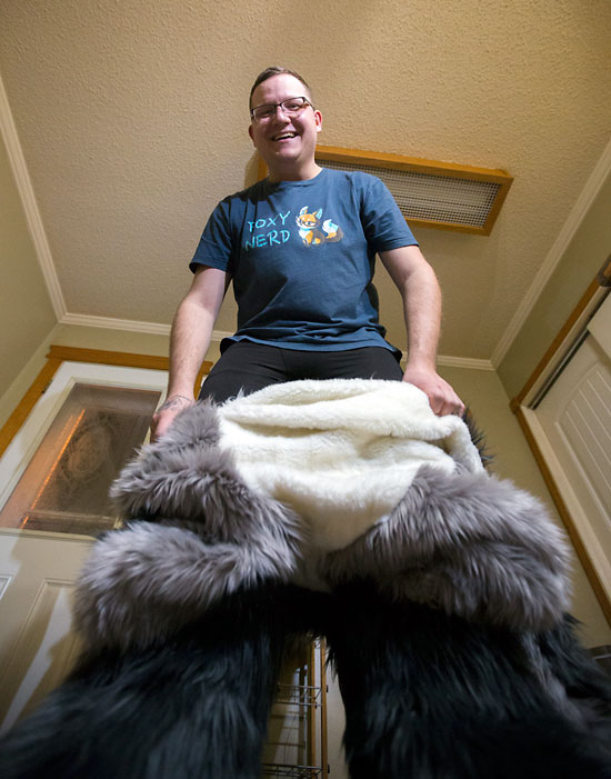 Justin Zinger, a.k.a. Toasty the Avocado Snep snow leopard, puts on his fur suit on Nov. 14.