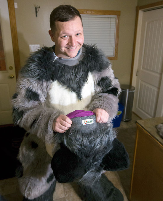 Justin Zinger, a.k.a. Toasty the Avocado Snep snow leopard, puts on his fur suit on Nov. 14.