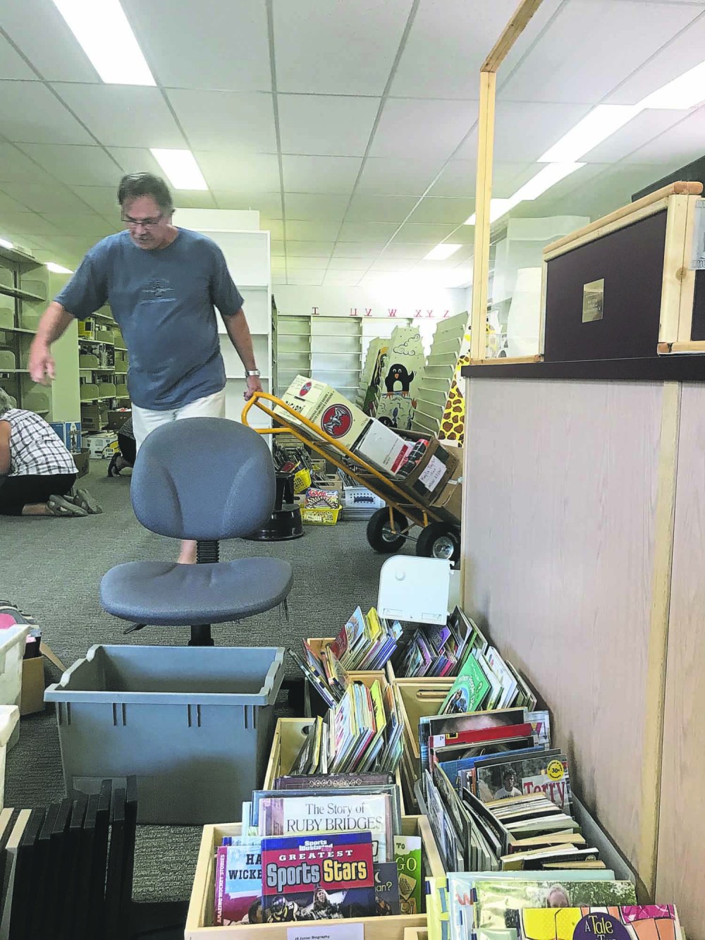 Submitted
Some local volunteers are hard at work removing books from Killarney's Lakeland Regional Library in August, hoping to make way for an upcoming round of renovations that include a new carpet and a fresh coat of paint.