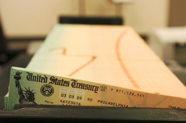 FILE - In this Feb. 11, 2005 file photo, trays of printed social security checks wait to be mailed from the U.S. Treasury's Financial Management services facility in Philadelphia. The government says the financial condition of the government’s two biggest benefit programs remains shaky. It indicates that Medicare is expected to become insolvent in just six years while Social Security will be unable to pay full benefits starting in 2035. (AP Photo/Bradley C. Bower, File)