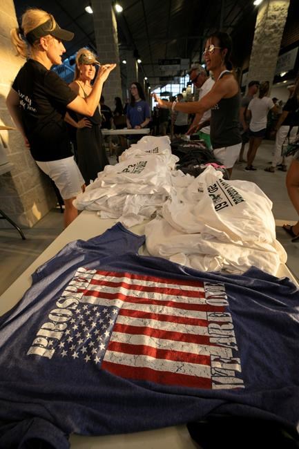 Shirts for sale during the opening of the new Children's Health Stadium at Prosper ISD on Saturday, Aug. 17, 2019 in Prosper, Texas. Democrats are out to show they’re serious about flipping Texas in 2020 by holding Thursday’s presidential debate in Houston. Republicans are coming off their worst election in Texas in a generation. Fast-changing suburbs are trending more liberal, and Democrats are counting on more left-leaning voters moving in to turn the state blue. But that transformation may not arrive by 2020, and the GOP is closely watching conservative bastions like the booming Dallas suburbs. (AP Photo/Nathan Hunsinger)