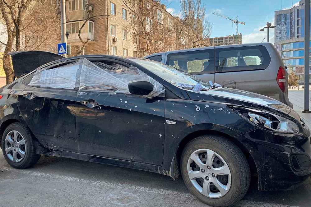 A car damaged by shelling that was used by Associated Press journalists to escape from the Mariupol blockade sits parked in Ukraine, Thursday, March 17, 2022. (Mstyslav Chernov / The Associated Press)
