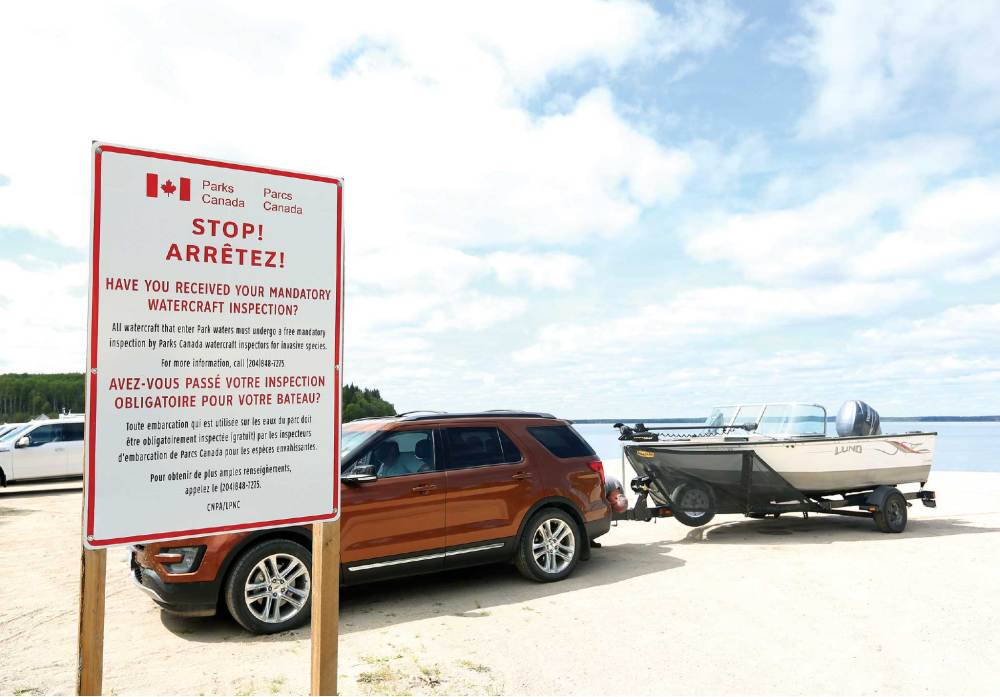 A sign posted at Clear Lake informing visitors of mandatory watercaft inspections.