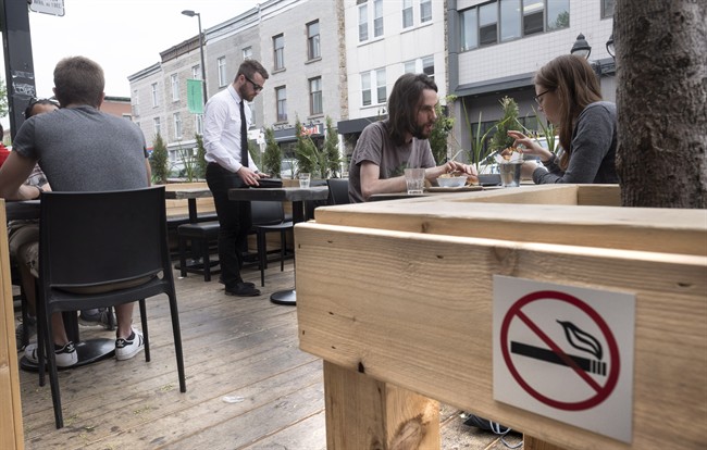 A no-smoking sign is seen on a patio Wednesday, May 25, 2016 in Montreal. Quebec's anti-smoking law will kick in Thursday prohibiting smoking on outdoor patios. THE CANADIAN PRESS/Paul Chiasson
