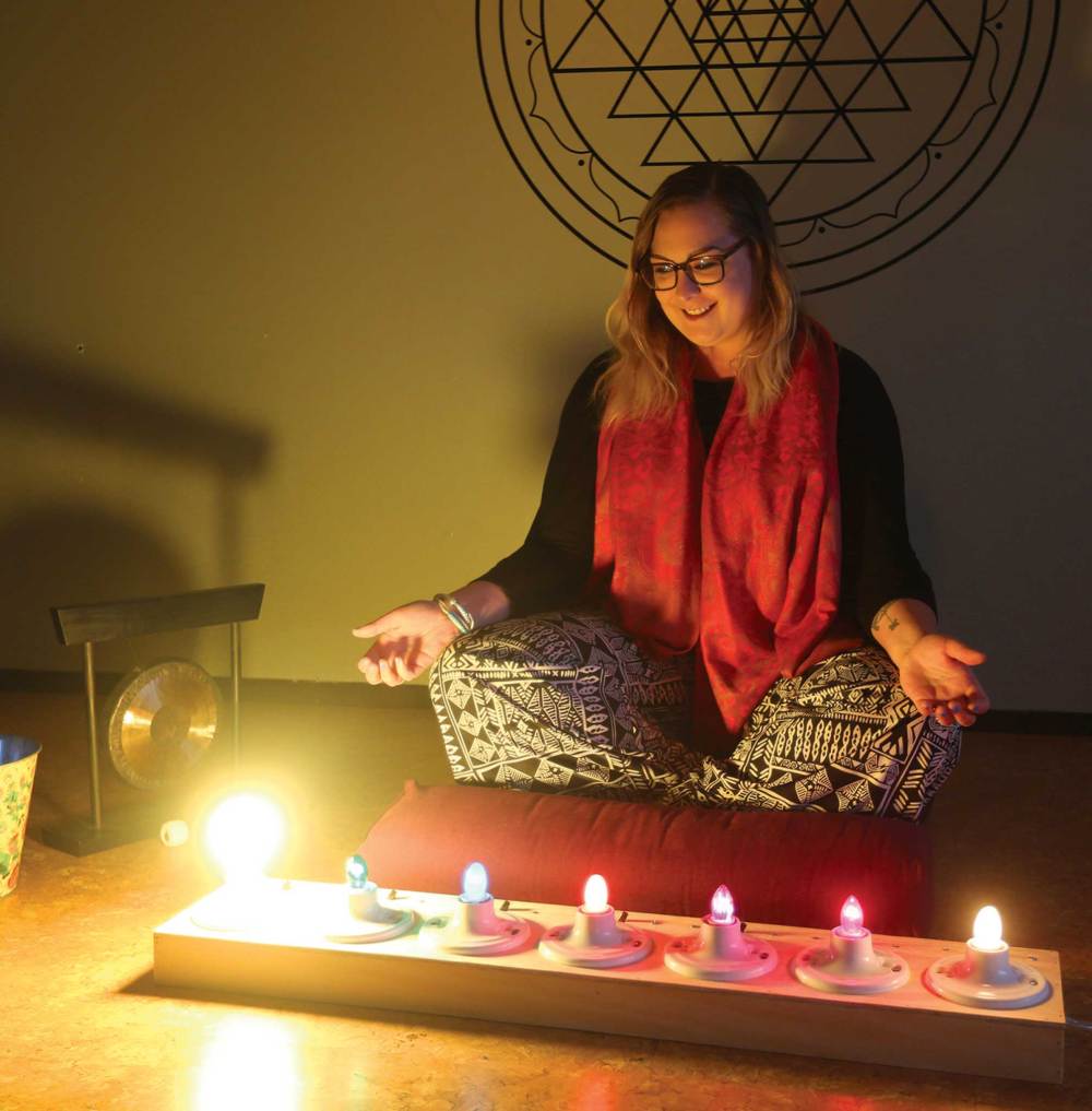 Meditation instructor Kristin Jette uses a light bar to symbolize the seven chakras. The bright light on the far left represents the crown chakra.