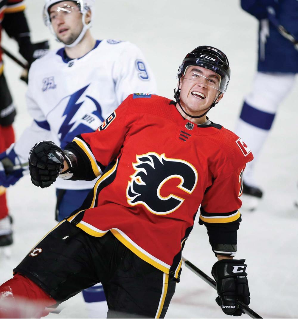The Canadian Press
Tampa Bay Lightning's Tyler Johnson, left, looks away as Calgary Flames' Micheal Ferlandcelebrates his goal during first period NHL hockey action in Calgary, Feb. 1.