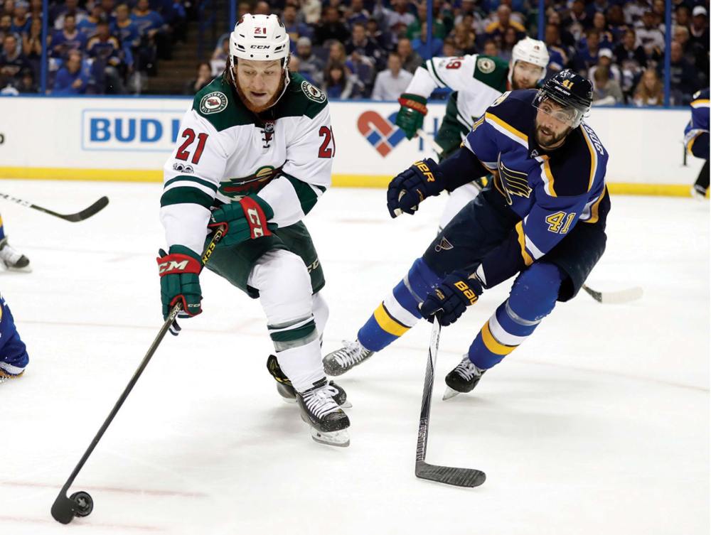 Associated Press
Minnesota Wild's Ryan White (21) controls the puck as St. Louis Blues' Robert Bortuzzo (41) defends during the first period in Game 3 of an NHL hockey first-round playoff series in 2017, in St. Louis.