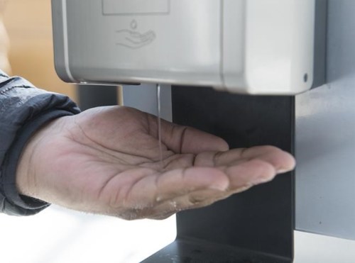 A man dispenses hand sanitizer in a shopping mall in the Montreal borough of Pointe-Claire, Saturday, March 14, 2020. For many distilleries that pivoted their operations and began making hand sanitizer two years ago amid a surge in demand for the disinfectant product in the early days of the COVID-19 pandemic, they have completely stopped and are no longer including it as a part of their business.THE CANADIAN PRESS/Graham Hughes