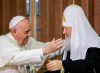 FILE — Pope Francis, left, reaches to embrace Russian Orthodox Patriarch Kirill after signing a joint declaration at the Jose Marti International airport in Havana, Cuba o Feb. 12, 2016. Pope Francis has sent a protocol greeting to the head of the Russian Orthodox Church, wishing him prayers on a feast day, as the Vatican insists on maintaining cordial relations amid mounting criticism of its stance from within the Catholic hierarchy. The website of the Moscow Patriarchate published the brief letter of greetings Francis sent Patriarch Kirill on his name day Tuesday to mark the feast of St. Cyril, a saint important to both Catholics and Orthodox. (AP Photo/Gregorio Borgia, Pool)