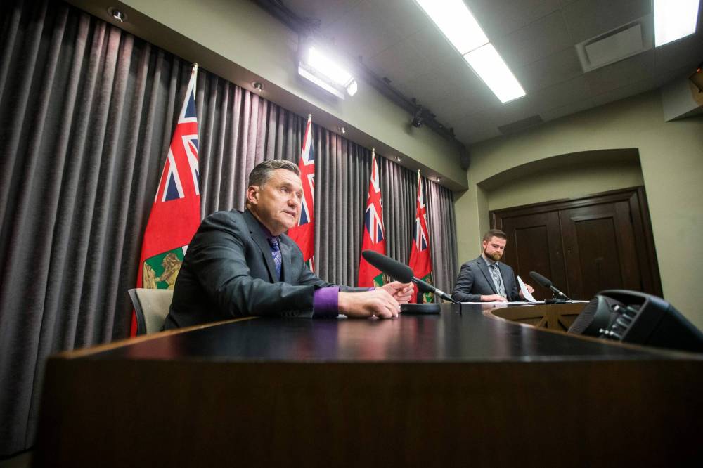 Doyle Piwniuk, transportation and infrastructure minister (left), and Johanu Botha, assistant deputy minister of emergency management and head of Manitoba's Emergency Management Organization, speak to the media about flood disaster financial assistance at the Manitoba Legislative Building Monday. (MIKAELA MACKENZIE / WINNIPEG FREE PRESS)