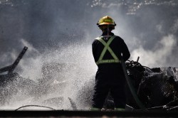 Matt Goerzen/The Brandon Sun
A member of the Brandon fire department uses a fire hose to douse the smokey ruins of the Christie