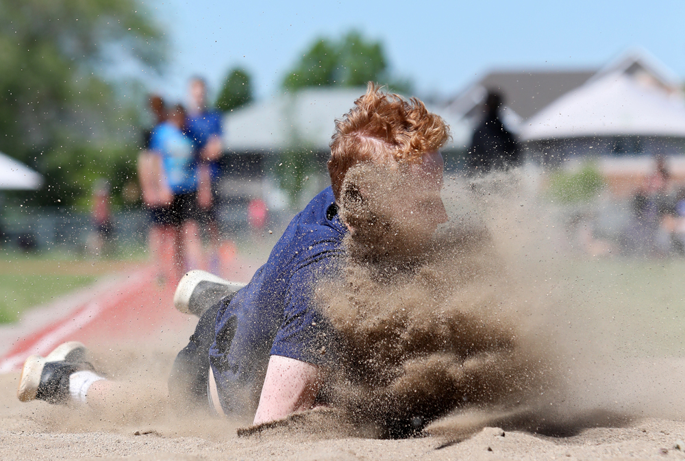 12062019
Skylar Ramsay of Kirkcaldy School kicks up sand after falling forward on his landing during the grade eight boys long jump event at the Brandon School Division Grade 7 & 8 City Track and Field Championship at UCT Stadium on Wednesday. 
(Tim Smith/The Brandon Sun)
