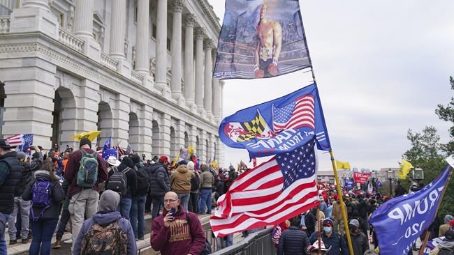 Rioters gather at the U.S. Capitol on Jan. 6, 2021, in Washington. The Jan. 6, 2021 insurrection at the U.S. Capitol played out for the world to see. But the House committee investigating the attack believes a more chilling story has yet to be told. (AP Photo/John Minchillo)