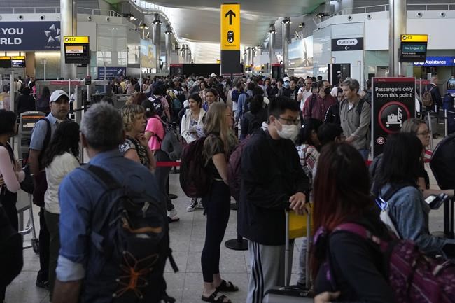 Travellers queue at security at Heathrow Airport in London, Wednesday, June 22, 2022. After two years of pandemic restrictions, travel demand is back with a vengeance but airlines and airports that slashed jobs during the depths of the COVID-19 crisis are struggling to keep up. With the busy summer tourism season underway in Europe, passengers are encountering chaotic scenes at airports, including lengthy delays, canceled flights and headaches over lost luggage. (AP Photo/Frank Augstein)
