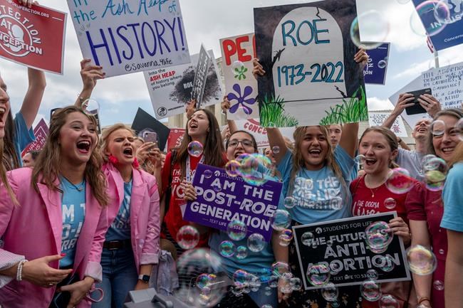 Anti-abortion protesters celebrate following Supreme Court's decision to overturn Roe v. Wade, federally protected right to abortion, outside the Supreme Court in Washington, Friday, June 24, 2022. The Supreme Court has ended constitutional protections for abortion that had been in place nearly 50 years, a decision by its conservative majority to overturn the court's landmark abortion cases. (AP Photo/Gemunu Amarasinghe)