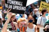 FILE - A person holds up a sign referencing the Stonewall Inn, during a queer liberation march for Black Lives Matter and against police brutality, Sunday, June 28, 2020, in New York. Parades celebrating LGBTQ pride kick off in some of America's biggest cities Sunday amid new fears about the potential erosion of freedoms won through decades of activism. The annual marches in New York, San Francisco, Chicago and elsewhere take place just two days after one conservative justice on the Supreme Court signaled, in a ruling on abortion, that the court should reconsider the right to same-sex marriage recognized in 2015. (AP Photo/Kathy Willens, File)