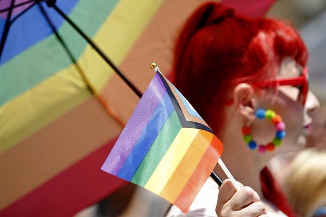 A participant holds a flag during the 51st Chicago Pride Parade in Chicago, Sunday, June 26, 2022. (AP Photo/Jon Durr)