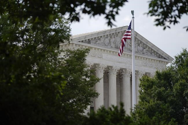 An American flag waves in front of the U.S. Supreme Court building, Monday, June 27, 2022, in Washington. (AP Photo/Patrick Semansky)