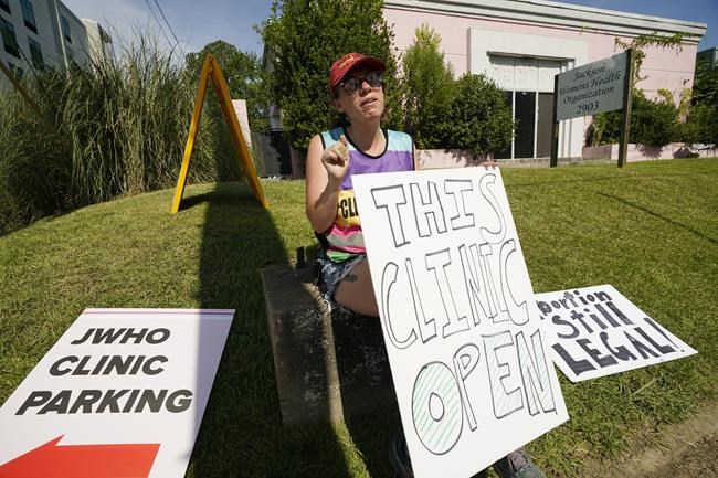 Clinic escort Ren Allen of Jackson, calls out to incoming patients that the Jackson Women's Health Organization clinic is open in Jackson, Miss., Saturday, June 25, 2022. The clinic is the only facility that performs abortions in the state. However, the U.S. Supreme Court overturned Roe v. Wade, ending constitutional protections for abortion. (AP Photo/Rogelio V. Solis)